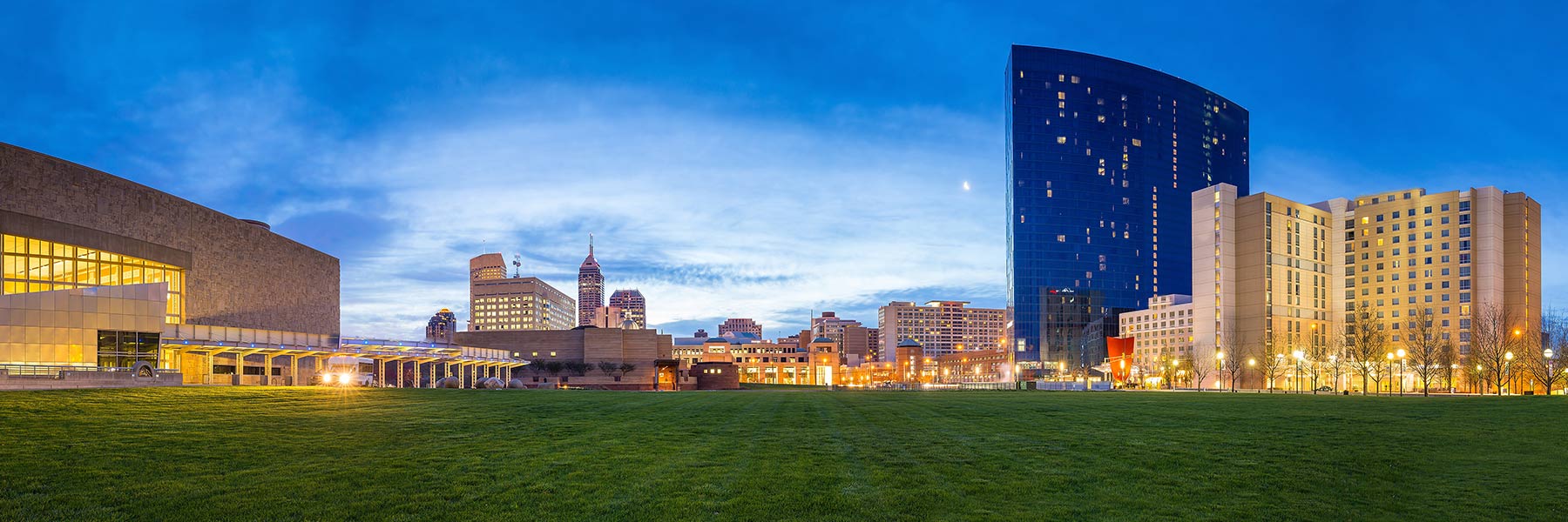 View looking across White River State Park toward the downtown Indianapolis skyline with the Indiana State Museum on the left and the JW Marriott hotel on the right 
